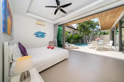 a living room with a white couch and a ceiling fan at 2BR Pool Villa Kate - KA Villas near Rawai Beach in Rawai Beach