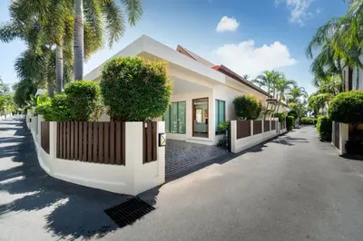 a house with a fence and trees on a street at 2BR Pool Villa Kate - KA Villas near Rawai Beach in Rawai Beach