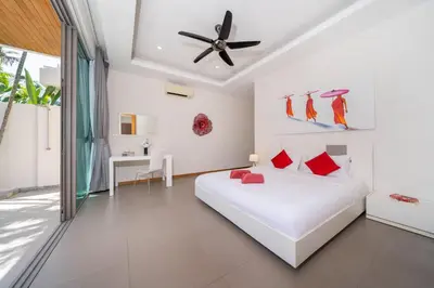 a white bedroom with a bed and a ceiling fan at 2BR Pool Villa Kate - KA Villas near Rawai Beach in Rawai Beach