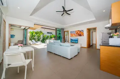 a living room with a white couch and a table at 2BR Pool Villa Kate - KA Villas near Rawai Beach in Rawai Beach