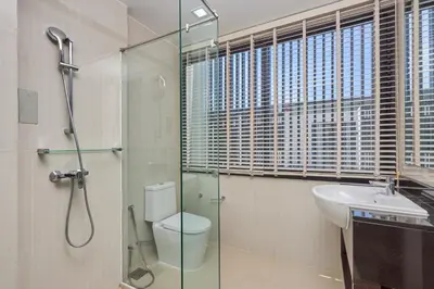 a bathroom with a shower and a toilet and a sink at Townhouse Laguna Park 3 bedrooms in Laguna Phuket