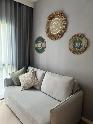 a living room with a couch and three mirrors at Bali Essence, The Title BangTao in Bang Tao Beach