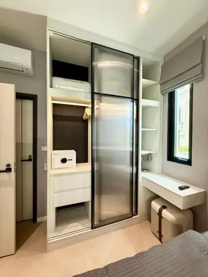 a room with a closet with a refrigerator and a desk at Bali Essence, The Title BangTao in Bang Tao Beach