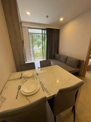 a room with a table and chairs and a couch at Пляж Бангтао Резиденция Ozon in Laguna Phuket