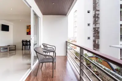 a balcony with two chairs and a table at Patong hillside Condo with pool, bar, parking in Patong Beach