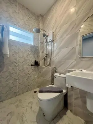 a bathroom with a toilet and a sink and a shower at Tiny house bangtao in Ban Thalat Choeng Thale