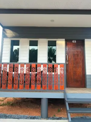 a house with a gate and a wooden door at The Nap Koh Yao Yai in Ban Nai Wat