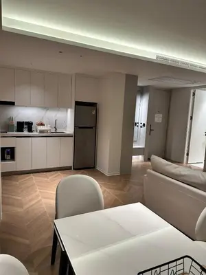 a living room with a couch and a table and a kitchen at Kora Beach Resort Residence 2 bedroom by Ere in Layan Beach