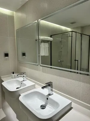 a bathroom with two sinks and a large mirror at Kora Beach Resort Residence 2 bedroom by Ere in Layan Beach