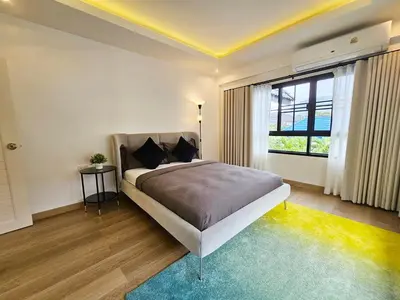 a bedroom with a bed and a large window at Boutique pool villa in Soi Bell,Kamala in Kamala Beach
