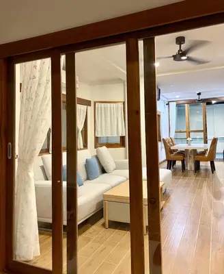 a living room with a white couch and a table at KONE- 3BR Private Pool Villa Kathu near Patong in Ban Kathu