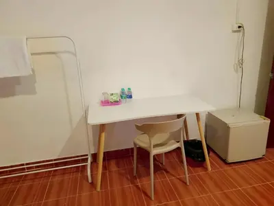 a white table and a chair in a room at GO INN Patong - โกอินน์ ป่าตอง in Patong Beach