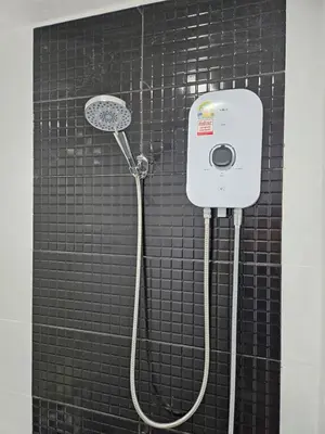 a black tiled bathroom with a shower with a shower head at Large 1 Bedroom Apt Sleeps 4, Close to Beach - RM 2 in Ban Lum Fuang