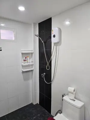 a bathroom with a shower with a toilet in it at Large 1 Bedroom Apt Sleeps 4, Close to Beach - RM 1 in Ban Lum Fuang
