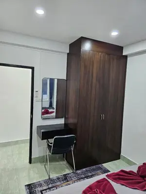 a bedroom with a desk and a closet and a bed at Large 1 Bedroom Apt, Sleeps 4, close to beach - RM 4 in Ban Lum Fuang