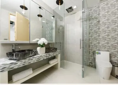 a bathroom with a toilet and a sink and a shower at Atika Villa 6 ocean view pool villa in Patong Beach