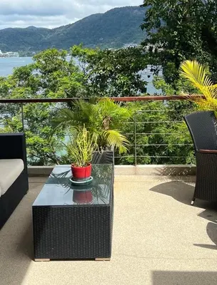a patio with a table with plants on it at Atika Villa 6 ocean view pool villa in Patong Beach
