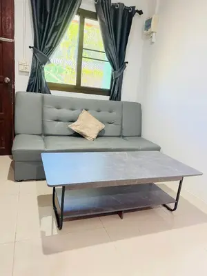 a coffee table in a living room with a couch at SINTO Homestay Yao Noi in Ko Yao Noi
