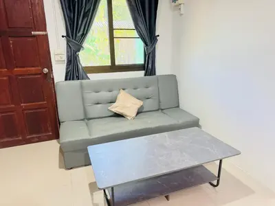a living room with a couch and a coffee table at SINTO Homestay Yao Noi in Ko Yao Noi