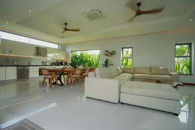 a living room with a white couch and a table at Villa Tropicana - Luxury 4 Bedroom Villa in Rawai Beach