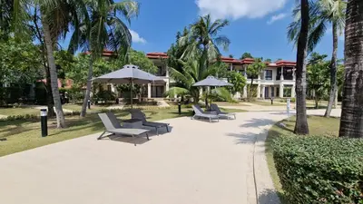 a group of chairs and umbrellas in a park at Desiner Villa in Laguna Village, Bang Tao Beach, Phuket in Layan Beach