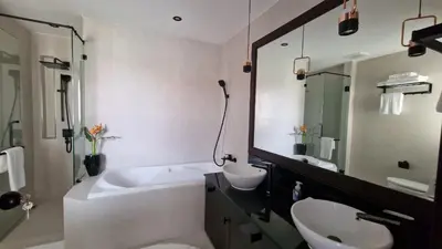 a bathroom with a tub and a sink and a bath tub at Desiner Villa in Laguna Village, Bang Tao Beach, Phuket in Layan Beach