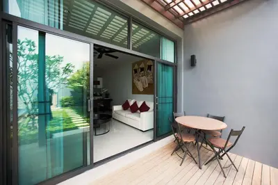 a living room with a table and a couch at VILLA Miriama 2 Bedroom Near Naiharn Beach in Rawai Beach