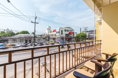a balcony with chairs and a view of a street at Le Hua Hotel in Phuket Town