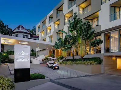 a car parked in front of a building at Andaman Beach Hotel Phuket - Handwritten Collection by Accor in Patong Beach