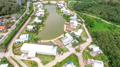 an aerial view of a village next to a river at TheLifeCo Phuket - Holistic Wellbeing Center in Nai Thon Beach