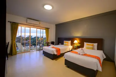 a hotel room with two beds and a balcony at Z-Talay House in Klong Muang Beach