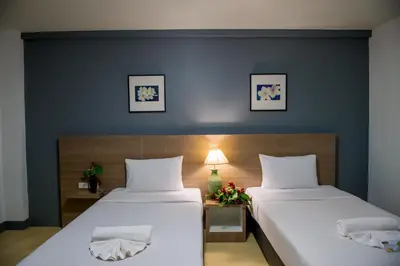 two beds in a room with blue walls at Z-Talay House in Klong Muang Beach