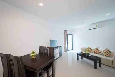 a living room with a table and a couch at Patong Bay Hill in Patong Beach