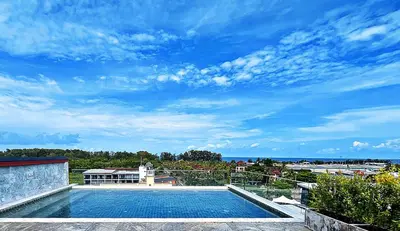 a swimming pool on top of a building with a blue sky at The Sixteenth Naiyang Beach Hotel- Free Schedule Airport Shuttle in Nai Yang Beach