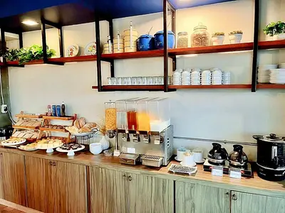 a kitchen with a counter with food on it at The Sixteenth Naiyang Beach Hotel- Free Schedule Airport Shuttle in Nai Yang Beach