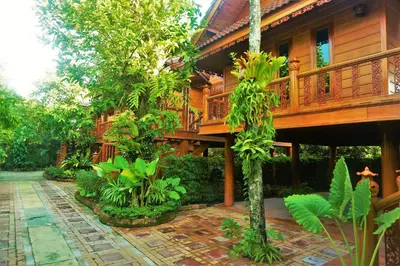 a large wooden house with atropical garden at Ruen Tai Boutique in Nai Yang Beach