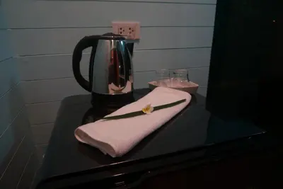a table with a blender and a napkin on it at Ruen Tai Boutique in Nai Yang Beach