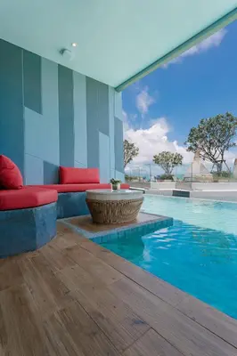 a living room with a pool with a large window at Crest Resort & Pool Villas - SHA Extra Plus in Patong Beach