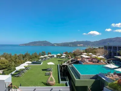 a view of a resort with a pool and the ocean at Crest Resort & Pool Villas - SHA Extra Plus in Patong Beach