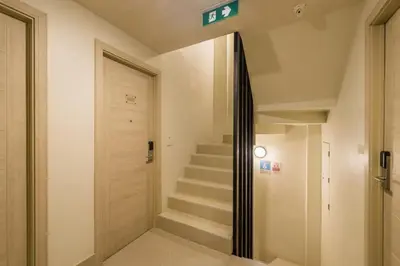 a hallway with stairs and a sign on the wall at Centro One Bangla in Patong Beach