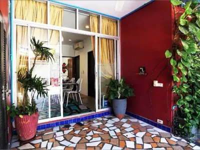 a room with plants on the side of a building at Phuket Paradiso in Chalong