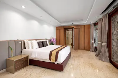 a bedroom with a large bed in a room at Luxury 4 pool Seaview 6 bedroom Villa on Surin Hill in Surin Beach