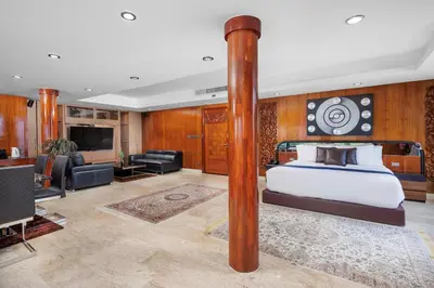 a bedroom with a bed and a living room at Luxury 4 pool Seaview 6 bedroom Villa on Surin Hill in Surin Beach