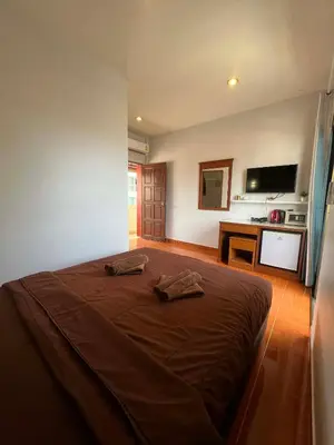 a bedroom with a bed with two towels on it at Ban Elephant Blanc Apartment in Kata Beach