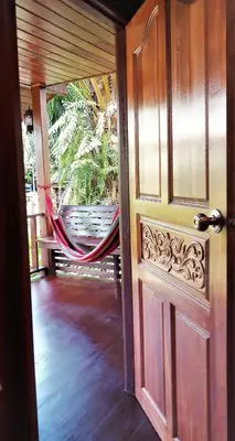 an open door to a porch with a hammock at Cozy Garden Resort in Ao Nang Beach