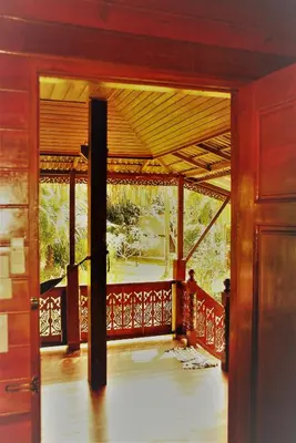 an open door of a house with a balcony at Cozy Garden Resort in Ao Nang Beach