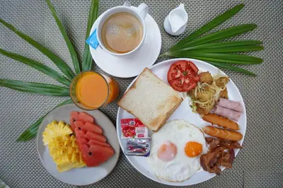 a plate of breakfast food with a cup of coffee at The Lai Thai Luxury Condominiums in Ao Nang Beach