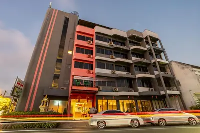 two cars parked in front of a building at Recenta Style Phuket Town in Phuket Town