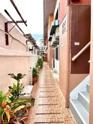 an empty alley with plants on the side of a building at JJ karon beach hotel in Karon Beach