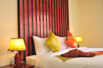 a hotel room with a bed with two lamps and two beds sidx sidx at Phi Phi Little Star Resort in Phi Phi Don